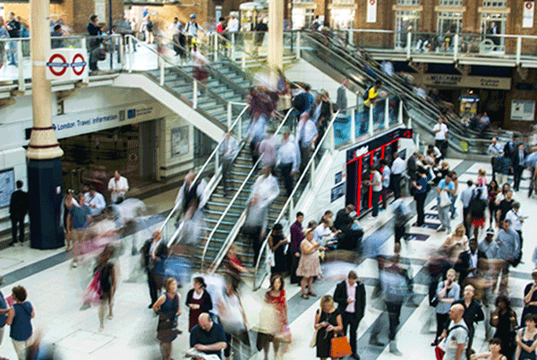 People rushing in a busy train station